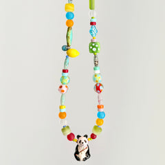 Colorful beaded necklace with a panda charm on a light gray background